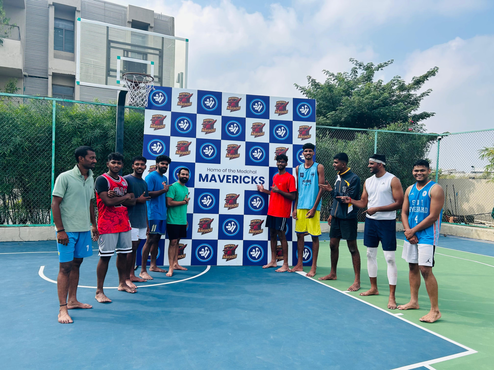 Medchal Mavericks squad gathered at the home court backdrop